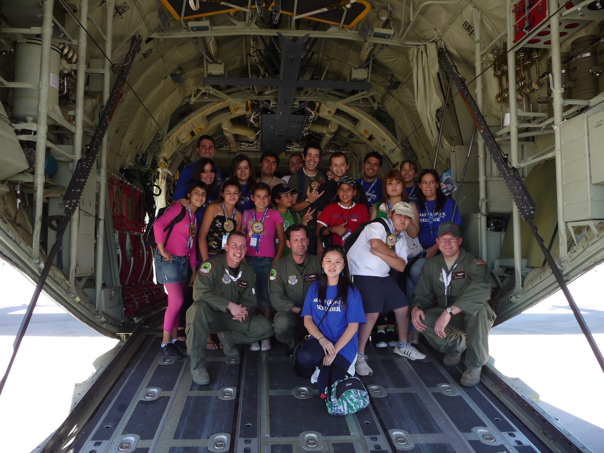 SANTIAGO, Chile -- Children from the Make a Wish Foundation, a charitable organization dedicated to assisting disabled and ill children around the world by creating once-in-a-lifetime memories, pose with members of the Texas Air National Guard during the FIDAE air and trade show in Santiago, Chile.  The group toured Air Force displays, sat in the cockpit of cargo aircraft and met with Airmen for several hours during the international event.  Airmen were so moved by their interaction with the young VIPs, at the conclusion of the show, the Air Force delegation made a personal donation to the Make a Wish program.