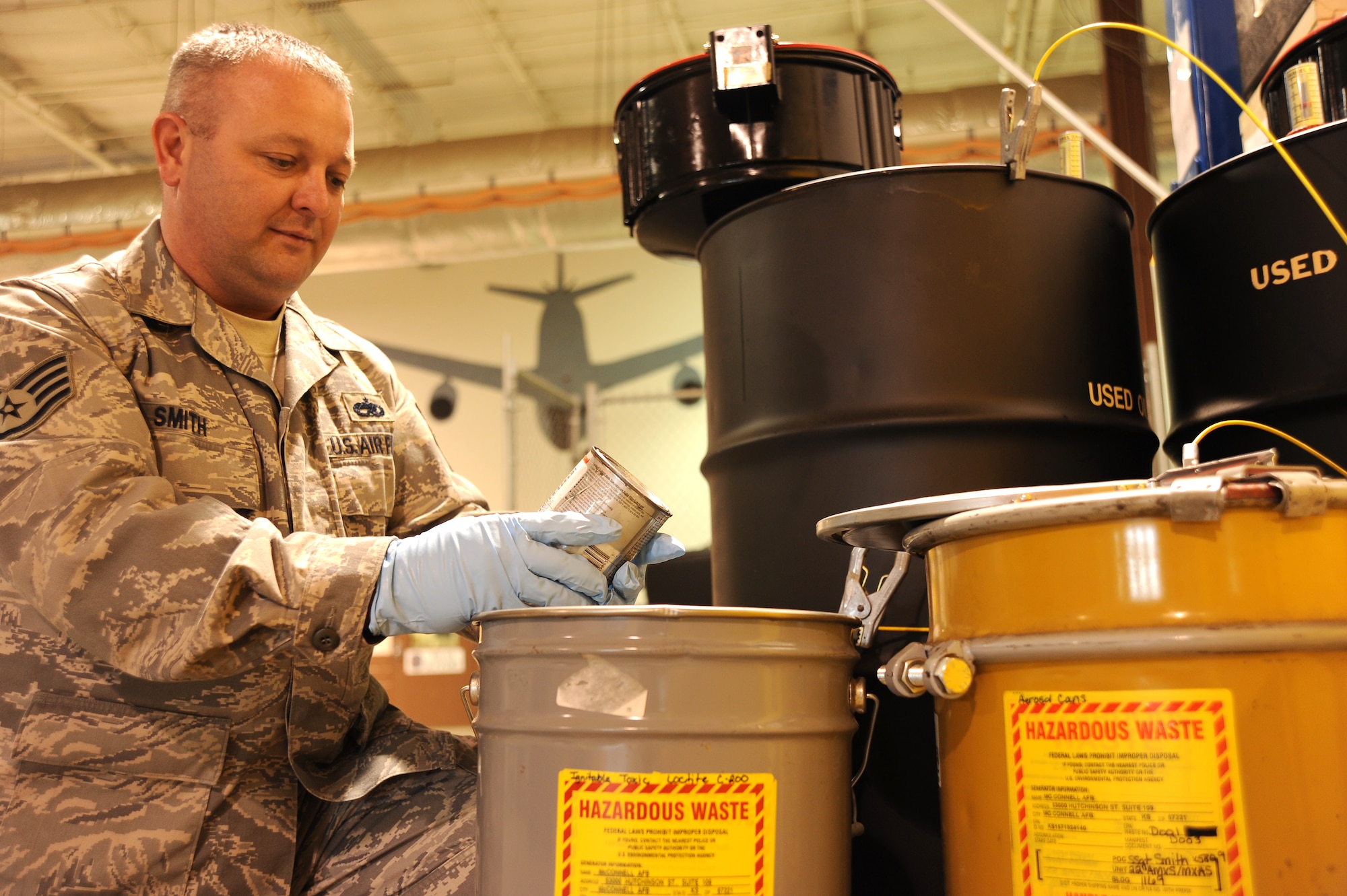 MCCONNELL AIR FORCE BASE, Kan. -- Staff Sgt. Cloyce Smith, 22nd Aircraft Maintenance Squadron hazardous material manager, checks a can of anti-seize Locitie C-200 compound before placing it into the hazardous waste container on April 9, 2010 at McConnell Air Force Base, Kan. KC-135 Stratotanker F108 engines can reach temperatures of 800 degrees Celsius or higher during take-off and anti-seize Locitie C-200 compound is used to prevents any metal-to-metal friction that may result. (U.S. Air Force photo/Tech. Sgt. Chyrece Campbell)