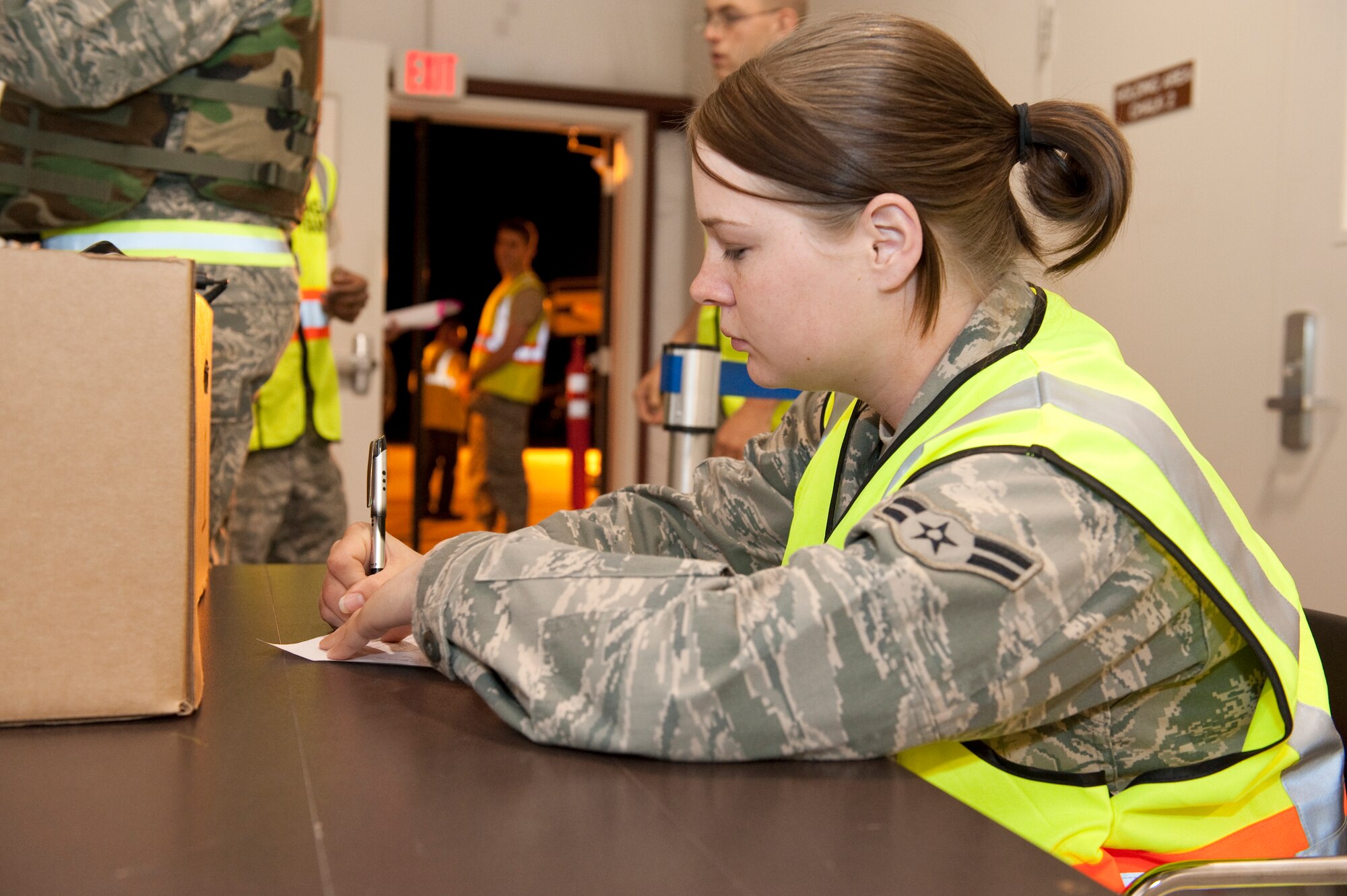 HOLLOMAN AIR FORCE BASE, N.M. -- Airman 1st Class Jessica Deer with the 49th Logistics Readiness Squadron's personnel deployment flight team processes personnel for a mock deployment, April 13, 2010, during a Phase I exercise. The 49th Fighter Wing is conducting a weeklong Phase I exercise to evaluate the wing's preparedness to deploy to any location, world-wide. During this event, the 49th FW will process over 450 personnel and 360 short tons of cargo using the same systems and procedures that they would use if called upon to deploy. (U.S. Air Force photo by Staff Sgt. Joe Laws / Released)