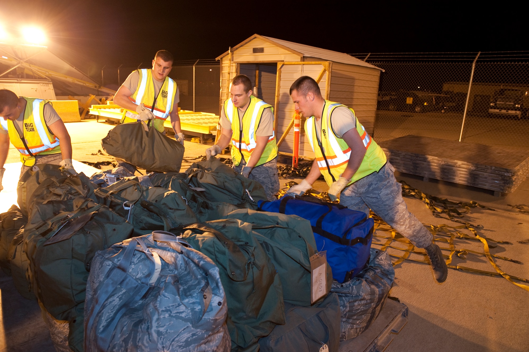 HOLLOMAN AIR FORCE BASE, N.M. -- Members of the 49th Logistics Readiness Squadron's bag handler team, palletizes mobility bags, April 13, 2010, during a Phase I exercise. The 49th Fighter Wing is conducting a weeklong Phase I exercise to evaluate the wing's preparedness to deploy to any location, world-wide. During this event, the 49th FW will process over 450 personnel and 360 short tons of cargo using the same systems and procedures that they would use if called upon to deploy. (U.S. Air Force photo by Staff Sgt. Joe Laws / Released)