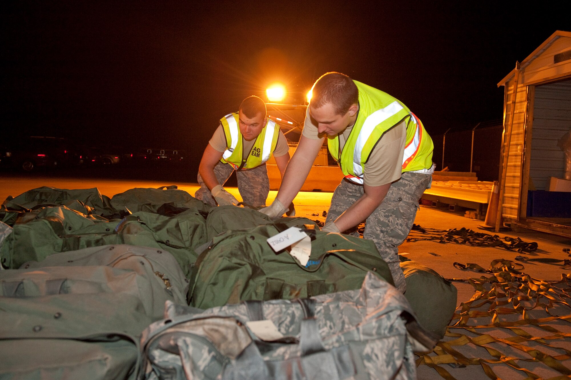 HOLLOMAN AIR FORCE BASE, N.M. -- Airman 1st Class Garrett Cantwell and Airman 1st Class Steven Martin, both with the 49th Logistics Readiness Squadron's bag handler team, palletizes mobility bags, April 13, 2010, during a Phase I exercise. The 49th Fighter Wing is conducting a weeklong Phase I exercise to evaluate the wing's preparedness to deploy to any location, world-wide. During this event, the 49th FW will process over 450 personnel and 360 short tons of cargo using the same systems and procedures that they would use if called upon to deploy. (U.S. Air Force photo by Staff Sgt. Joe Laws / Released)