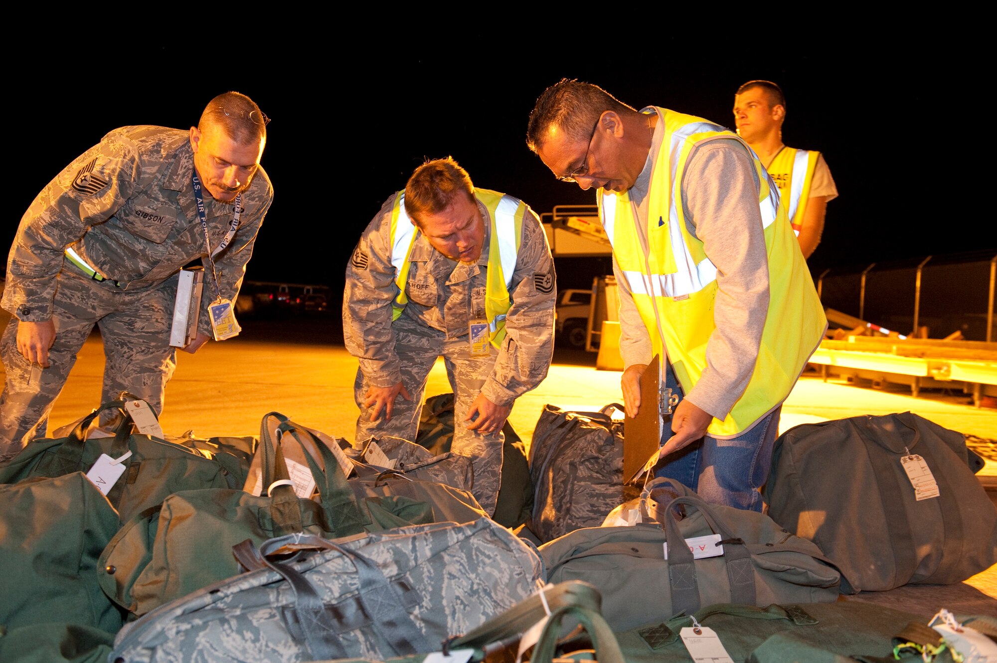 HOLLOMAN AIR FORCE BASE, N.M. -- Members of the Holloman Exercise Evaluation Team inspect baggage tags, April 13, 2010, during a Phase I exercise. The 49th Fighter Wing is conducting a weeklong Phase I exercise to evaluate the wing's preparedness to deploy to any location, world-wide. During this event, the 49th FW will process over 450 personnel and 360 short tons of cargo using the same systems and procedures that they would use if called upon to deploy. (U.S. Air Force photo by Staff Sgt. Joe Laws / Released)