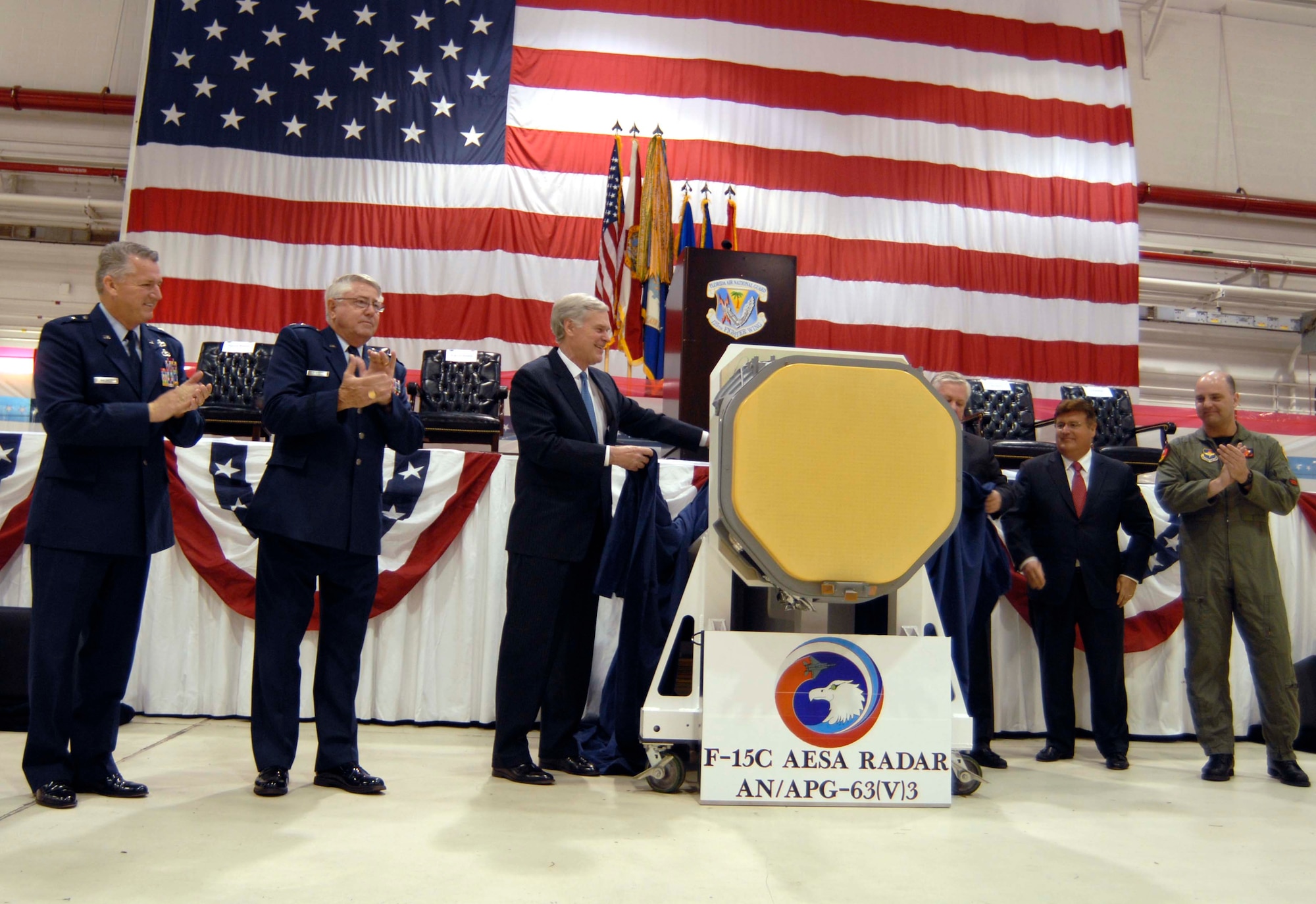 Congressman Ander Crenshaw (center) helps unveil the new APG-63(v)3 Active Electronically Scanned Array during a rollout ceremony at the 125th Fighter Wing in Jacksonville, Fla., April 12, 2010. Flanked by Air National Guard leaders - including the Adjutant General of Florida Maj. Gen. Douglas Burnett (second from left) - and representatives from Boeing and Raytheon, the congressman helped introduce the upgrade for the National Guard's F-15 Eagle fighter aircraft. Photo by Master Sgt. Thomas Kielbasa