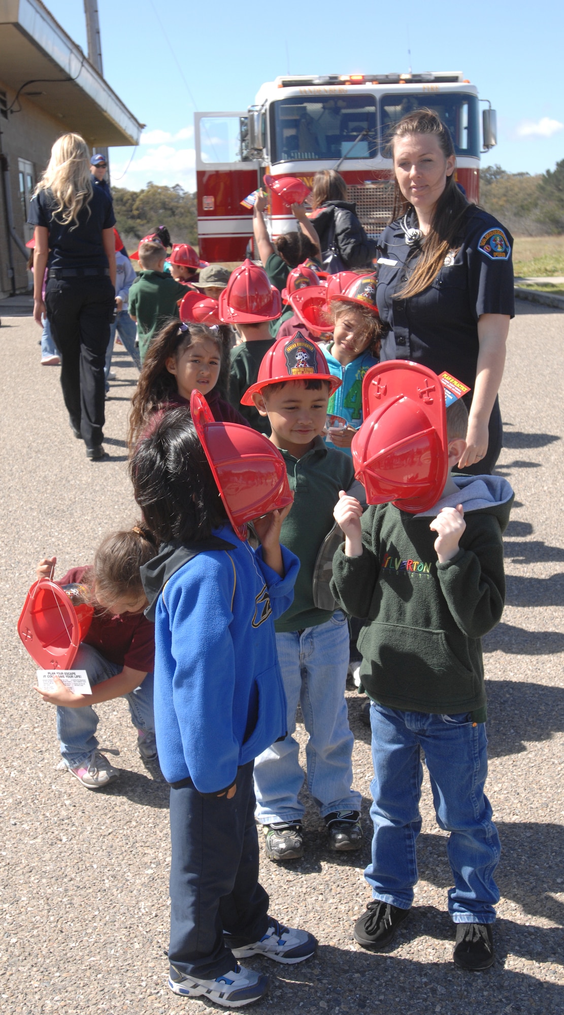 VANDENBERG AIR FORCE BASE, Calif. – Elizabeth Beecher, a 30th Civil Engineer Squadron emergency dispatcher, gathers students of Manzanita Elementary School during the 9-1-1 For Kids event here Tuesday, April 13, 2010. Approximately 230 students from Manzanita Elementary School attended the event. (U.S. Air Force photo/Senior Airman Christopher Hubenthal) 
