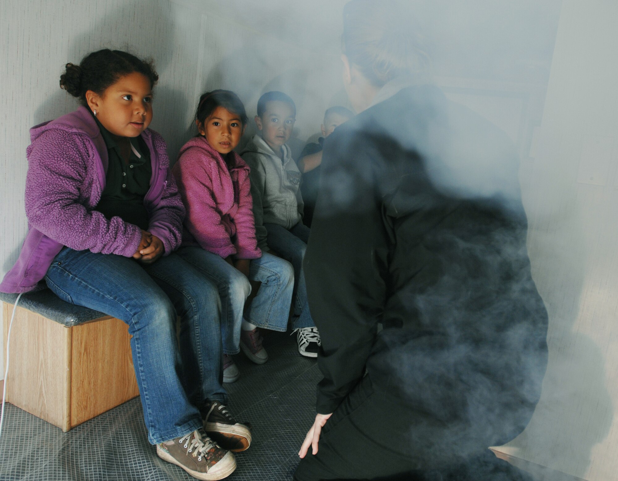 VANDENBERG AIR FORCE BASE, Calif. – As non-toxic, simulated smoke enters the room, Traci Betty, a 30th Civil Engineer Squadron fire inspector, explains what Manzanita Elementary School students need to do to get to safety during the 9-1-1 For Kids event here Tuesday, April 13, 2010. The exercise focused on teaching general fire safety tips, the functions of smoke alarms, the “stop, drop and roll” technique, and how to evacuate a room. (U.S. Air Force photo/Senior Airman Christopher Hubenthal) 
