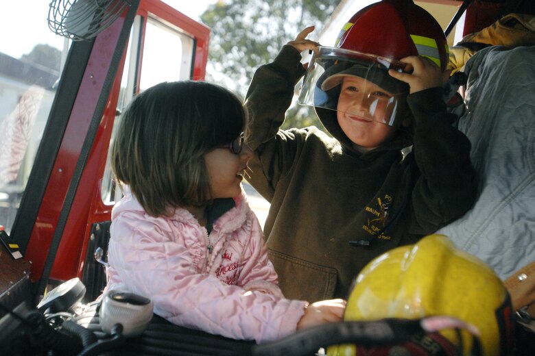 VANDENBERG AIR FORCE BASE, Calif. – Bella Mulder and Mark Ainsworth, Manzanita Elementary School kindergarten students, try on firefighter personal protective equipment during the 9-1-1 For Kids event here Tuesday, April 13, 2010. Approximately 230 students from Manzanita Elementary School attended the event. (U.S. Air Force photo/Senior Airman Christopher Hubenthal) 