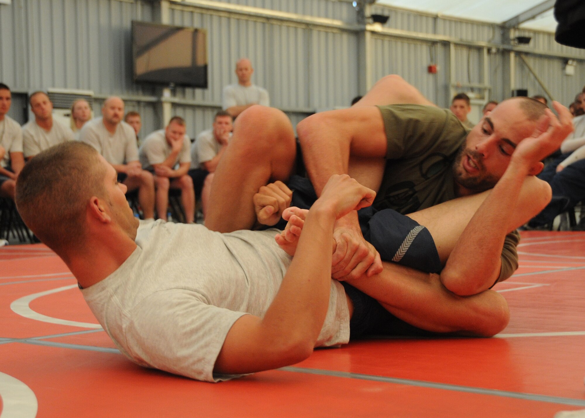 Ultimate Fighter Championship fighter Mike Swick demonstrates various moves used to submit opponents at an undisclosed location in Southwest Asia on April 04, 2010. The 380th Air Expeditionary Wing, supports Operations Iraqi Freedom and Enduring Freedom and the Combined Joint Task Force-Horn of Africa. The 380th AEW is comprised of four groups and 12 squadrons and the wing's deployed mission includes air refueling, surveillance and reconnaissance in support of overseas contingency operations in Southwest Asia. (U.S. Air Force photo/Senior Airman Jenifer H. Calhoun/Released)
