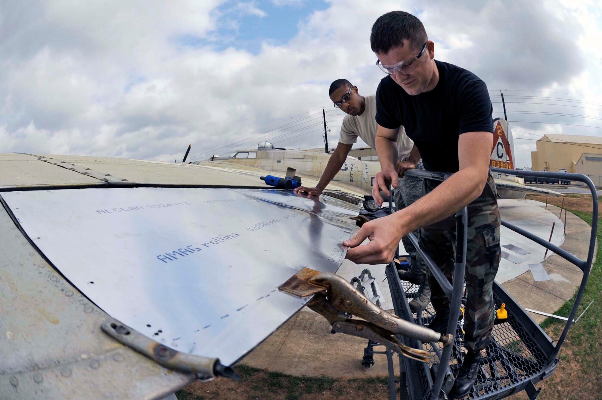 Airmen 1st Class Bronson Bohannon (right) and Avondries Green install rivets on new sheet metal wing flaps April 5, 2010, at Barksdale Air Force Base, La. Airmen Bohannon and Green are 2nd Maintenance Squadron aircraft structural maintainers. (U.S. Air Force photo/Staff Sgt. John Gordinier)