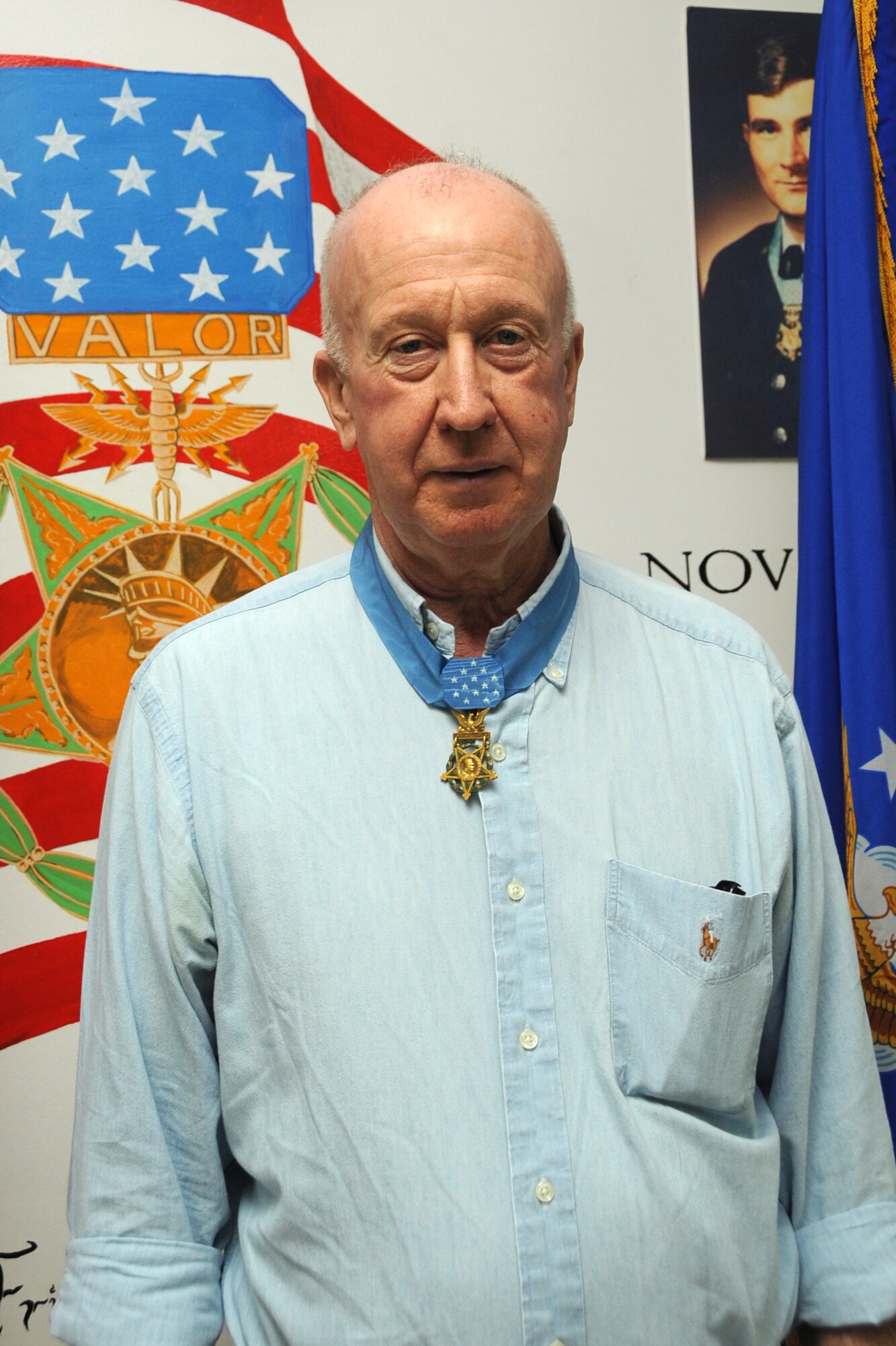 Medal of Honor winner Don Jenkins poses in front of a Medal of Honor mural at an undisclosed location in Southwest Asia on April 12, 2010. The 380th Air Expeditionary Wing, supports Operations Iraqi Freedom and Enduring Freedom and the Combined Joint Task Force-Horn of Africa. The 380th AEW is comprised of four groups and 12 squadrons and the wing's deployed mission includes air refueling, surveillance and reconnaissance in support of overseas contingency operations in Southwest Asia. (U.S. Air Force photo/Senior Airman Jenifer H. Calhoun/Released)
