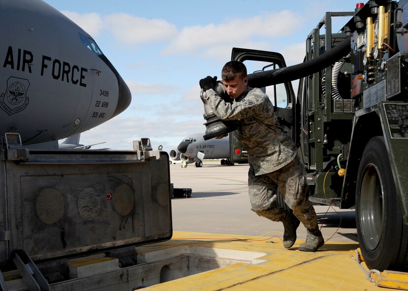 MCCONNELL AIR FORCE BASE, Kan. -- Airman 1st Class Chantz Wyant, 22nd Logistics Readiness Squadron fuels distribution apprentice, extends a fuel hose from a hydrant servicing vehicle toward an underground hydrant pit, April 7, 2010, McConnell Air Force Base, Kan. The fuel and air sensing lines allow the fuel from the hydrant pit to flow through the truck and into the aircraft safely. The hose pumps 350 to 600 gallons per minute and is used approximately ten times per day. (U.S. Air Force photo/Airman 1st Class Andrea Salazar)