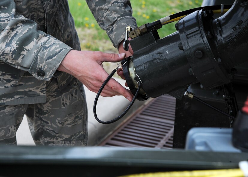 MCCONNELL AIR FORCE BASE, Kan. -- Airman Jacob Baxendale, 22nd Logistics Readiness Squadron fuels distribution operator, replaces the cap of a fuel storage tank after loading fuel into the truck, April 6, 2010, McConnell Air Force Base, Kan. The cap is called a dust cover and is used to prevent any foreign objects from entering the storage tank. (U.S. Air Force photo/Airman 1st Class Andrea Salazar)