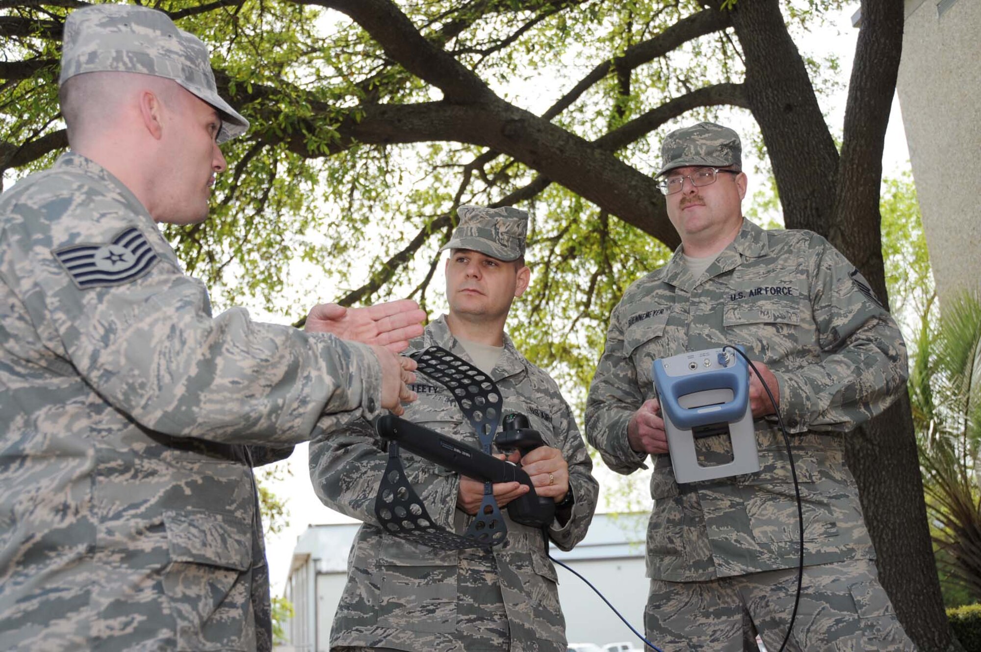 From left, Sergeant Cook introduces Master Sgts. Scott Leety and Greg Buennemeyer to the FSH6 spectrum analyzer that will be used in the course that begins today in McClelland Hall.  The equipment measures spectrum occupancy and direction finding.  (U.S. Air Force photo by Kemberly Groue)
