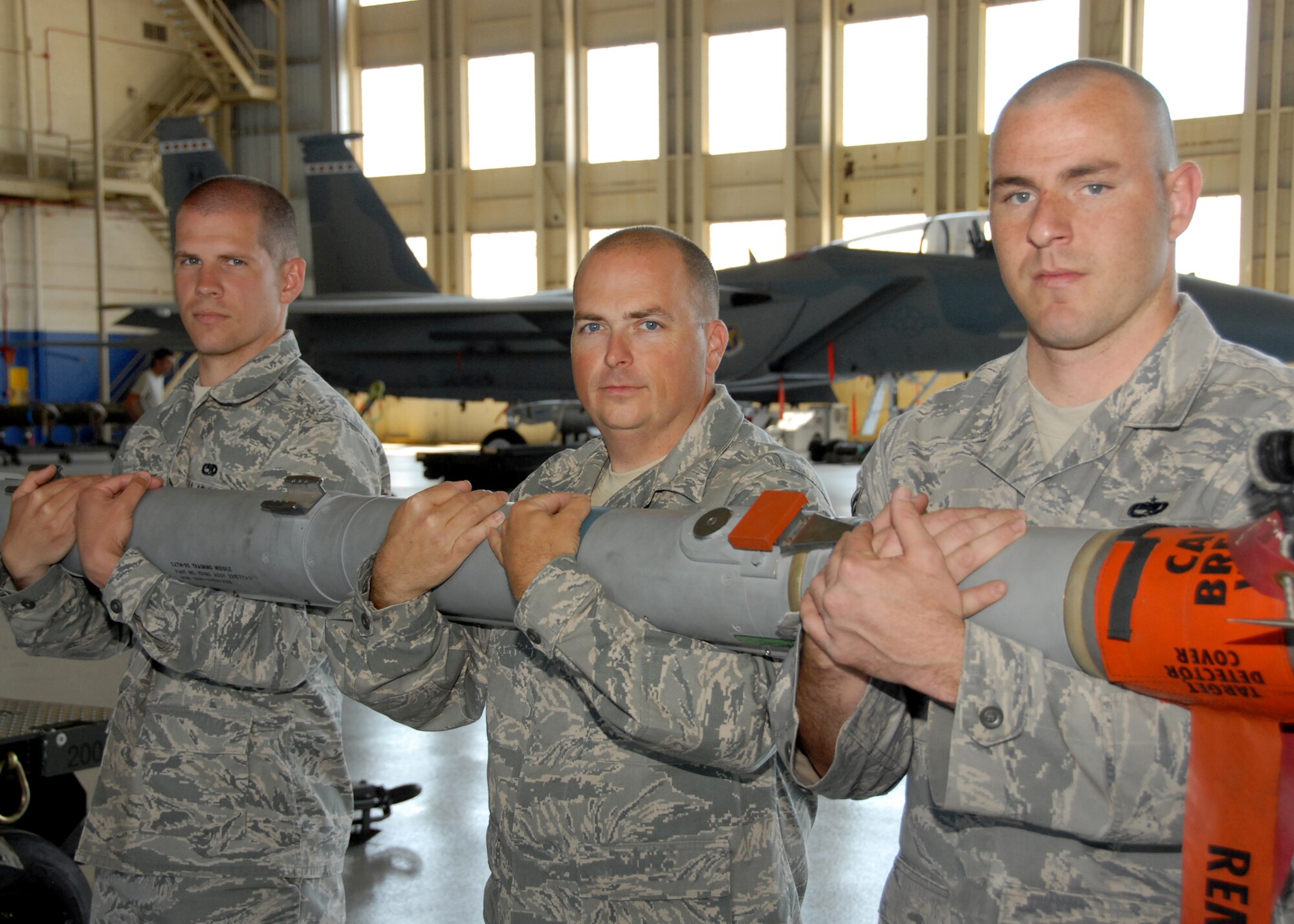 Left to right – Senior Airman Seth Ellerbe, Master Sgt. Greg Young and Staff Sgt. William Merritt, 46th Maintenance Group, hold their weapon of choice the AIM-9X April 13 at Eglin Air Force Base.  Each Airmen pictured won the Maintenance Professional of the Year award for his category and garnered a “clean sweep” of enlisted MPOY awards for the 46th Maintenance Group.  (U.S. Air Force photo/Samuel King Jr.)
