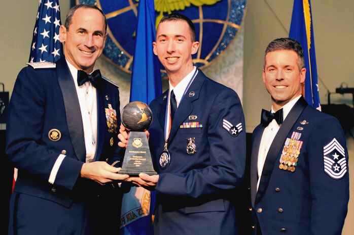 Senior Airman Samuel Siewert, 628th Civil Engineer Squadron fire protection journeyman, is named 2009 Air Mobility Command Airman of the Year April 8, 2010, by AMC Commander Gen. Raymond Johns and AMC Command Chief Master Sgt. David Spector at an award ceremony at the Scott Club at Scott AFB, Ill. Airman Siewert was one of four Airmen selected for top honors in their respective categories of Airman, NCO, Senior NCO and First Sergeant. With his selection as AMC Airman of the Year, Airman Siewert will now go on to compete among Airmen from around the Air Force in the 12 Outstanding Airmen of the Year competition. (U.S. Air Force photo/Senior Airman Wesley Farnsworth)