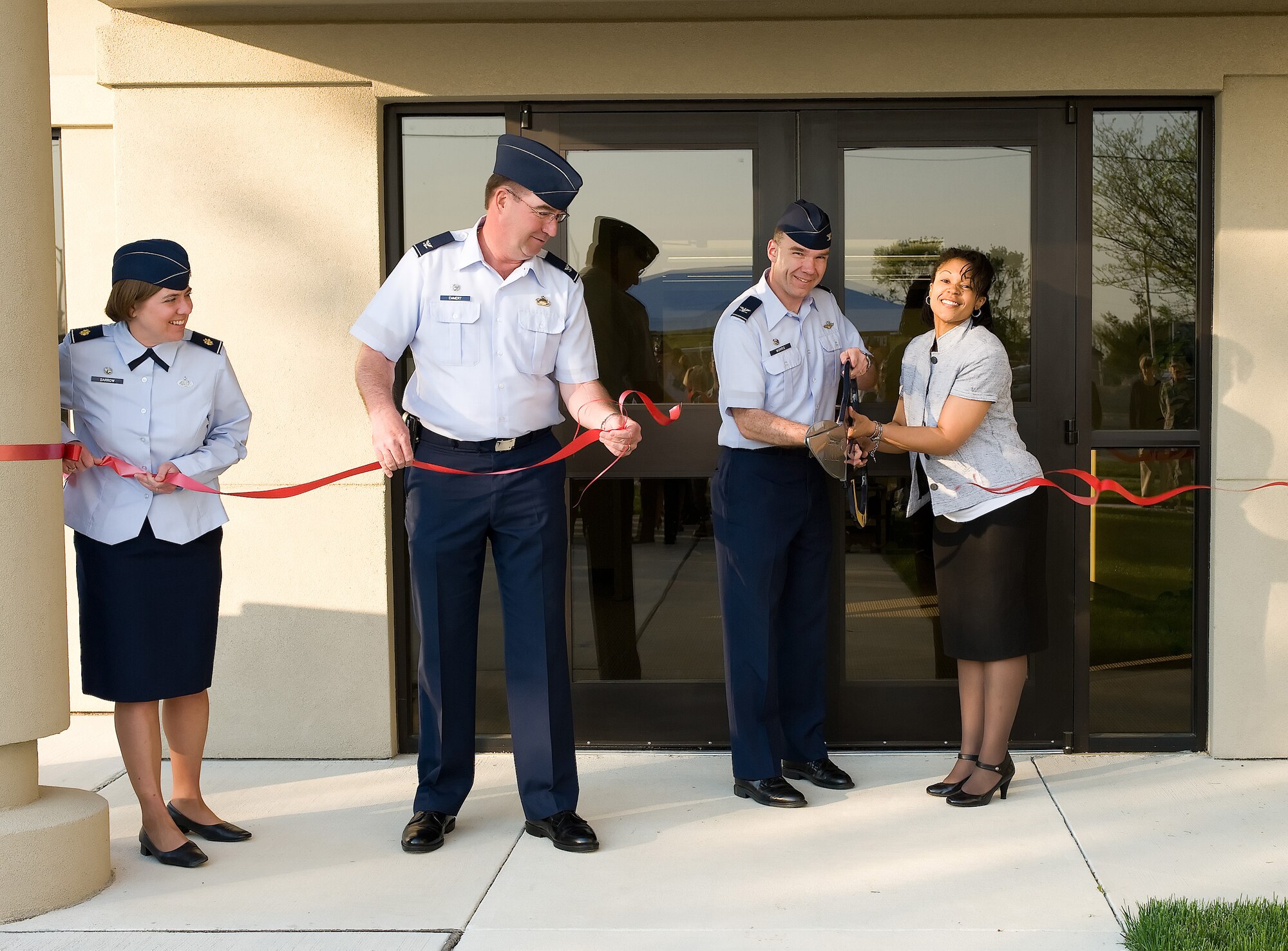 (From right) Portia Fennell, 436th Force Support Squadron education flight chief; Col. Manson Morris, 436th Airlift Wing commander; and Col. Todd Emmert, 436th Mission Support Group commander, cut the ribbon on the new Dover Education Office outside building 261 April 12.  (U.S. Air Force photo/Jason Minto) 