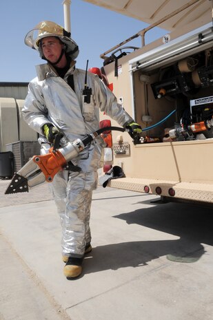 Senior Airman Samuel Siewert moves out  the "jaws of life" for training during operations at a non-disclosed base in Southwest Asia on March 14, 2010. As an Air Force firefighter, Airman Siewert and his fellow firefighters are responsible for protecting thousands of deployed personnel and billions of dollars of Air Force assets from fire. He is deployed from the 628th Civil Engineer Squadron fire department at Joint Base Charleston, S.C., and his hometown is Oconomowoc, Wisc. (U.S. Air Force Photo/Master Sgt. Scott T. Sturkol)