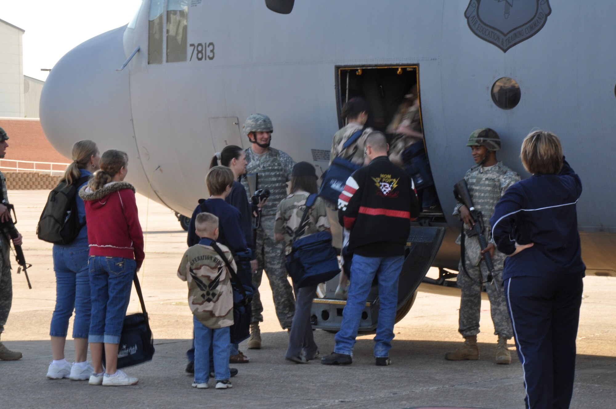 Children board a C-130 trainer aircraft that will transport them to Base “X” during the Operation KIDS event April 10. Operation KIDS, an annual event held at Sheppard helps children in military families understand and experience the processes their parents go through during deployments. (U.S. Air Force Photo/Airman 1st Class Adawn Kelsey)