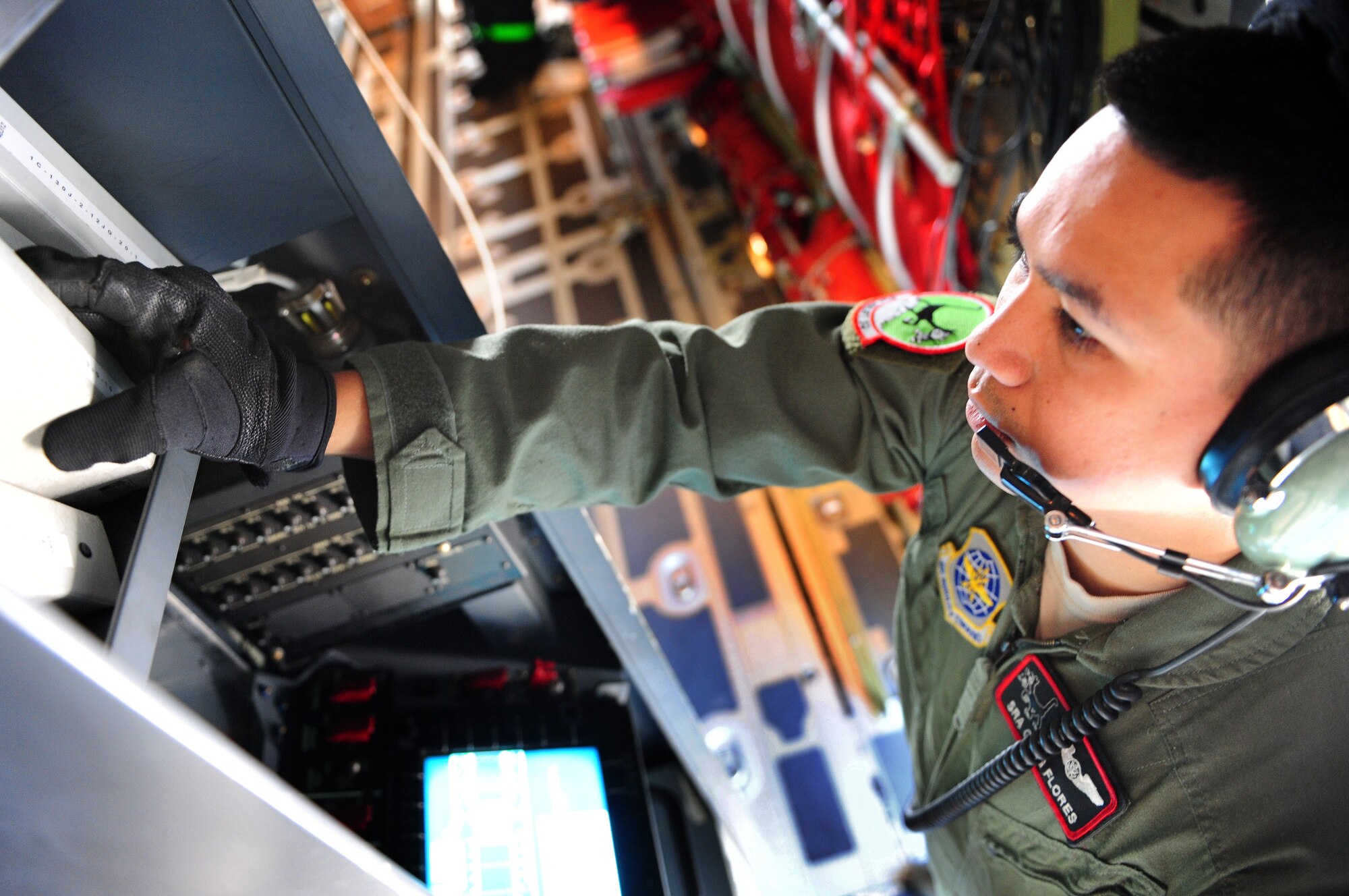 Senior Airman Gregory Flores, 41st Airlift Squadron C-130J loadmaster, completes required tasks before departure on a C-130J aircraft April 13. Airman Flores was an invaluable crewmember during the Haiti Relief effort where he helped deliver $1.2 million in lifesaving equipment to the devastated country. (U.S. Air Force photo by Senior Airman Steele C. G. Britton)