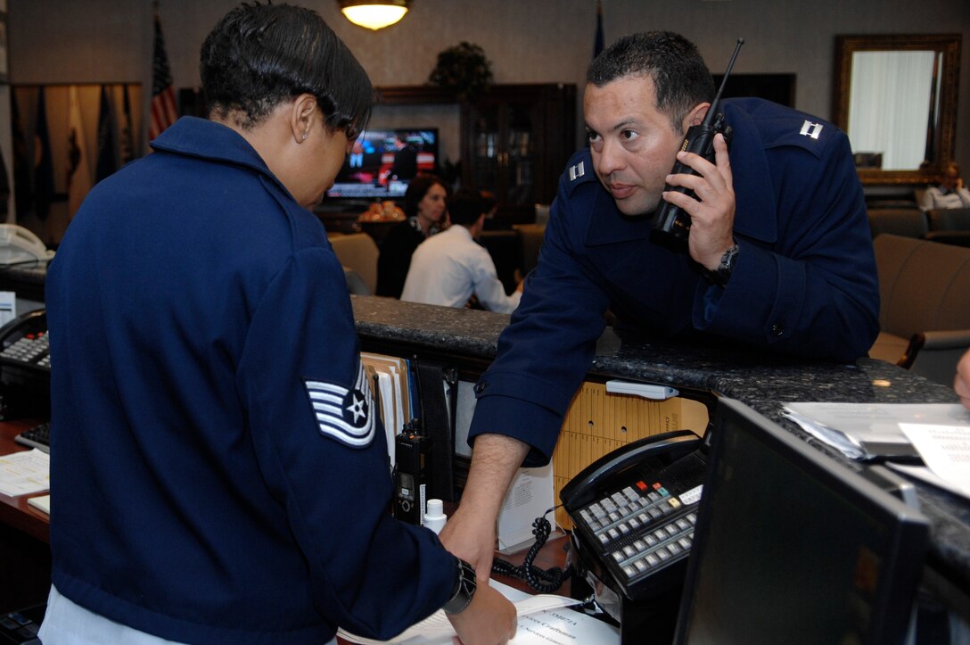 Technical Sgt. Barbara Brooks, 316th Wing Protocol specialist, left, and Capt. Nester Jimenez, 316 WG Protocol officer, right, review information April 13, 2010, in preparation for the departure of foreign dignitaries attending the Nuclear Security Summit, who will be departing from Joint Base Andrews, Md., over the next two days. The 316 WG is leading operations to provide safe, effective and efficient departure services for the invited guests transiting Andrews. (U.S. Air Force photo by Airman 1st Class Melissa V. Brownstein)