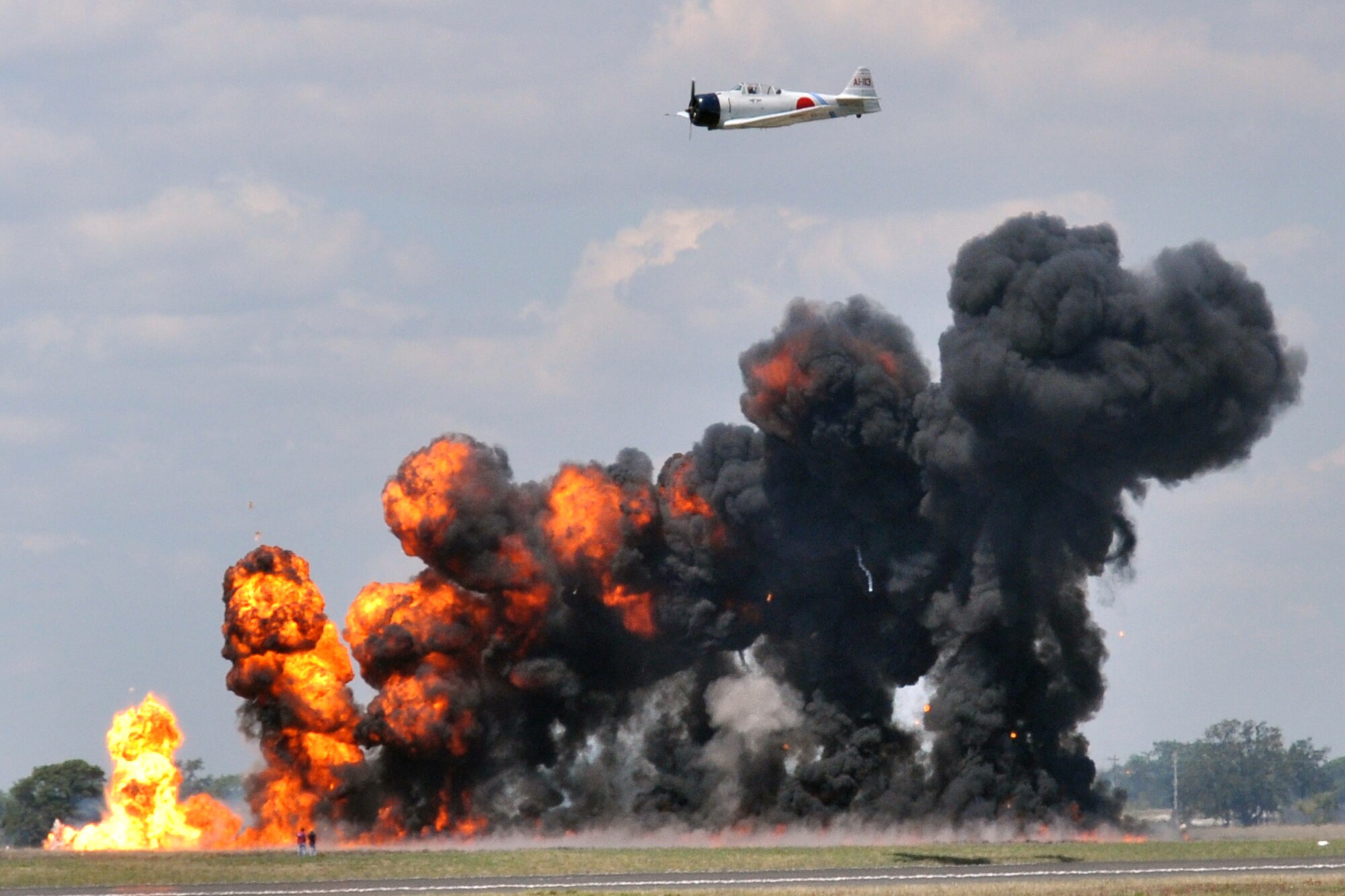 EGLIN AIR FORCE BASE, Fla. -- A T-6 Texan rebuilt to resemble Japanese Zero flies away as pyrotechnics detonate during “Tora, Tora, Tora” show at the 75th Anniversary Air Show April 11. More than 125,000 were in attendance during the air show April 10-11, enjoying a variety of aerial performances and static displays. This was Eglin’s first open house since 2007 and was timed to coincide with the 75th anniversary of the installation. The Thunderbirds, F-22A Raptor demo and “Tora, Tora, Tora” were some of the highlights of the event. (U.S. Air Force photo/ Airman 1st Class Anthony Jennings)