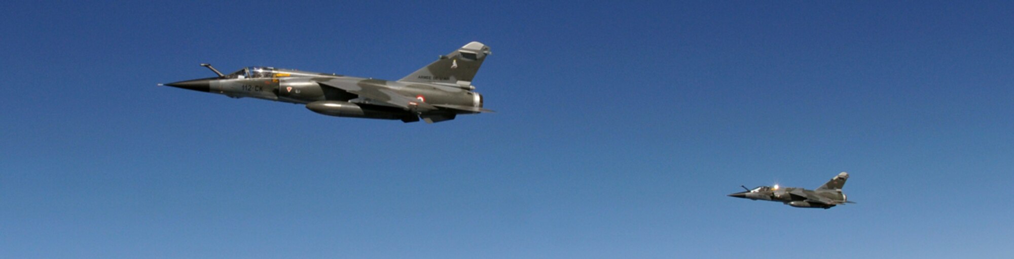 RAF MILDENHALL, England – A pair of French Mirage F1 fighters fly off the wing of a 100th Air Refueling Wing KC-135 during Exercise BRILLIANT ARDENT April 14.  Sixty aircraft ranging from fighters, attack aircraft, helicopters, tanker and airborne early warning aircraft are operating from air bases located in Germany, the Czech Republic, France, Poland, and UK. (U.S. Air Force photo/Staff Sgt. Austin M. May)