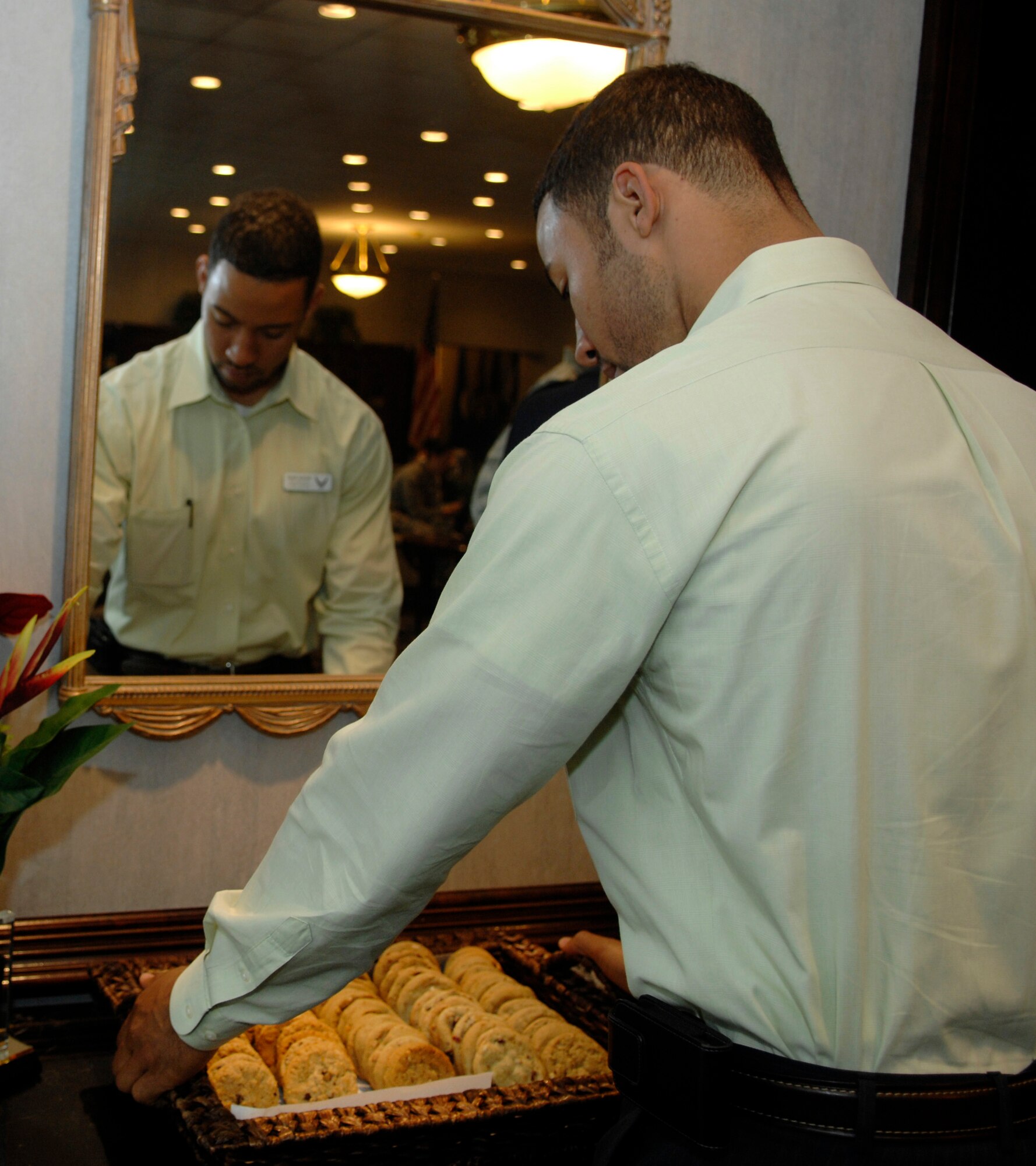 Gerome Banks, 316th Wing Protocol specialist, puts out freshly baked cookies at the distinguished visitors lounge in preparation for the Mexican President's departure from Joint Base Andrews, Md., after having attended the Nuclear Security Summit April 13, 2010. The 316 WG is leading operations to provide safe, effective and efficient departure services for the invited guests transiting Andrews. (U.S. Air Force photo by Airman 1st Class Melissa V. Brownstein)