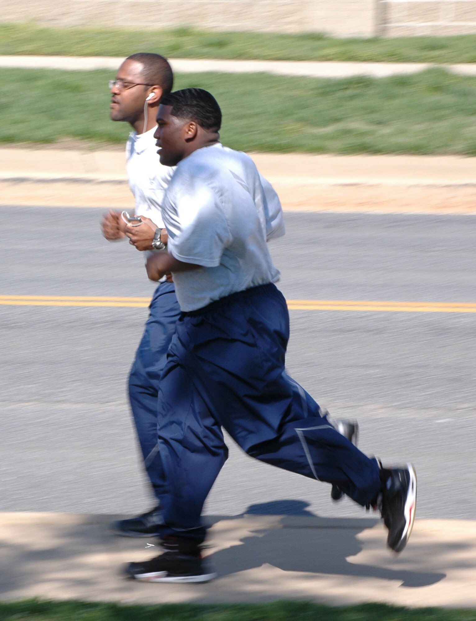 Senior Airman Darnell Robinson and Airman 1st Class Cedric Middleton, 512th Logistics Readiness Flight supply managers, run April 10 during the April unit training assembly weekend. The flight?s workout included strength training and running designed to improve members? physical test scores. (U.S. Air Force photo/Staff Sgt. James Bolinger)