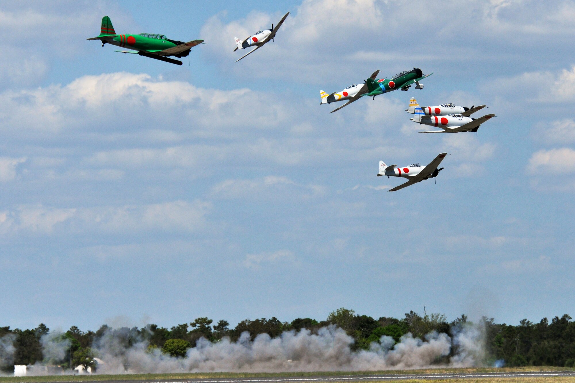 EGLIN AIR FORCE BASE, Fla. – A group of T-6 Texans rebuilt to resemble Japanese Zeros break formation as pyrotechnics detonate during “Tora, Tora, Tora” show at the 75th Anniversary Air Show April 11. More than 125,000 were in attendance during the air show April 10-11, enjoying a variety of aerial performances and static displays. This was Eglin’s first open house since 2007 and was timed to coincide with the 75th anniversary of the installation. The Thunderbirds, F-22A Raptor demo and “Tora, Tora, Tora” were some of the highlights of the event. (U.S. Air Force photo/ Airman 1st Class Anthony Jennings)
