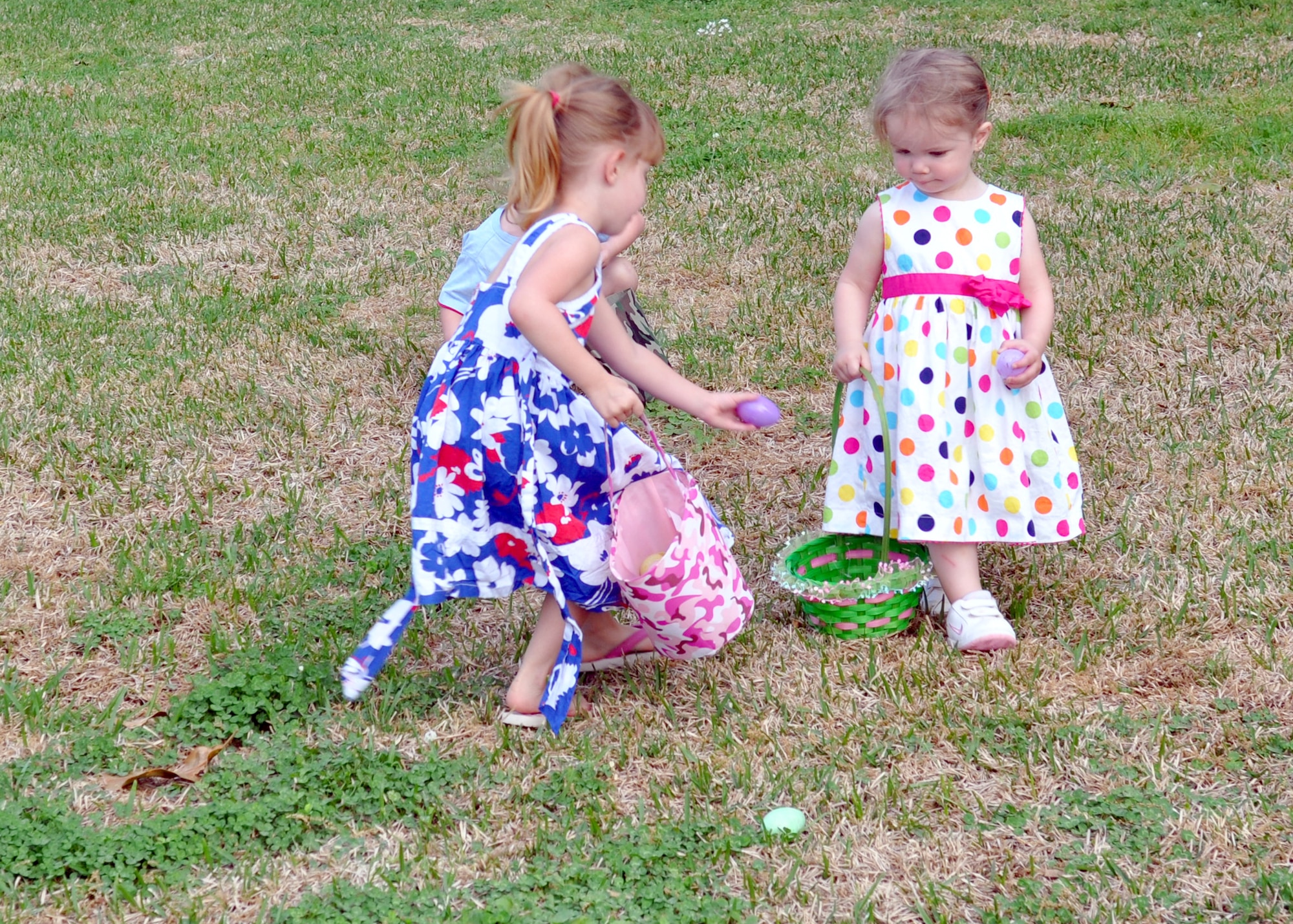 Stevie Willey, the daughter of a daycare provider on Barksdale Air Force Base, La., shares her eggs with some of the younger children attending Stephanie Willey’s Daycare Easter Egg Hunt on April 2, 2010. This daycare is one of many on Barksdale which gives servicemembers the opportunity to leave their children with a care provider with an at-home atmosphere.  (U.S. Air Force Photo/Senior Airman Crystal Marie Jordan)
