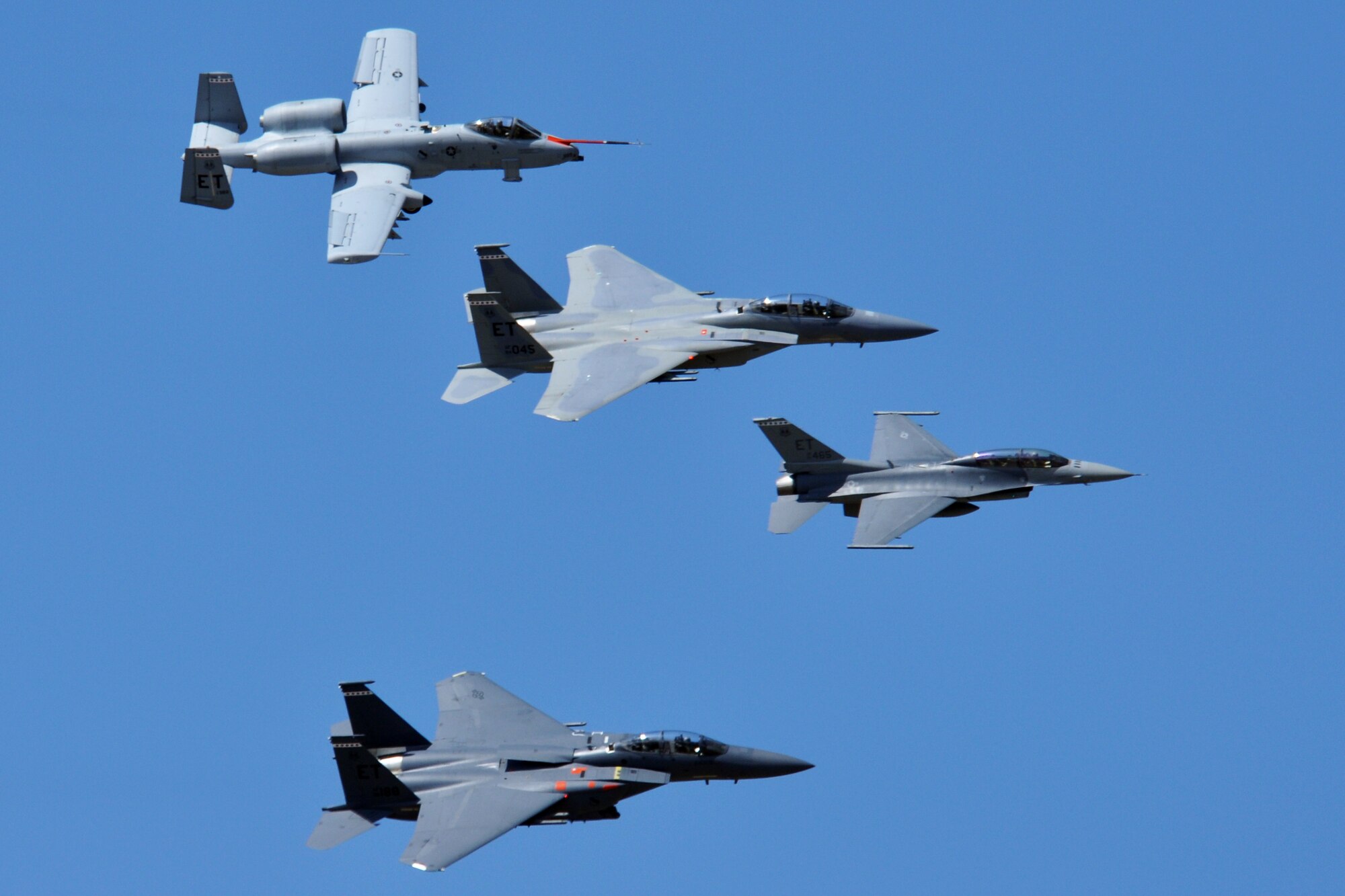 EGLIN AIR FORCE BASE, Fla. – (top to bottom) A 46th Test Wing A-10 Warthog, F-15C Eagle, F-16 Fighting and an F-15E Strike Eagle perform a formation flyby during the 75th Anniversary Air Show April 11. More than 125,000 were in attendance during the air show April 10-11, enjoying a variety of aerial performances and static displays. This was Eglin’s first open house since 2007 and was timed to coincide with the 75th anniversary of the installation. The Thunderbirds, F-22A Raptor demo and “Tora, Tora, Tora” were some of the highlights of the event. (U.S. Air Force photo/ Airman 1st Class Anthony Jennings)