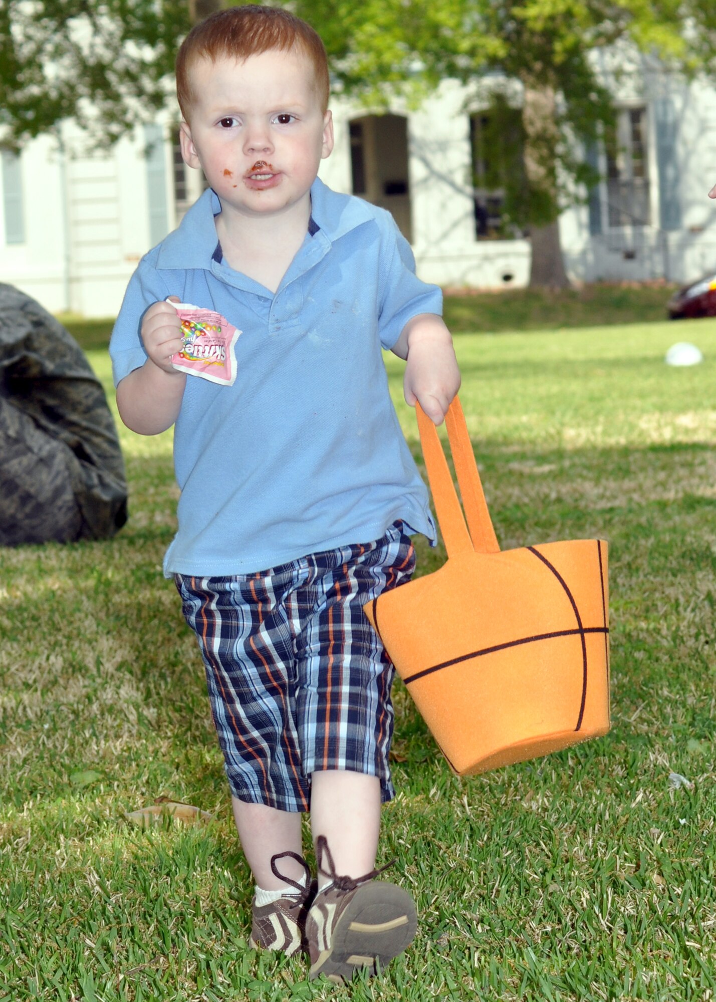 Aiden Rideout, one of the children attending Stephanie Willey’s Daycare Easter Egg Hunt on Barksdale Air Force Base, La., enjoys the spoils of victory during the hunt April 2, 2010. Aiden is one of the Barksdale dependants enrolled in the base’s childcare program. He is also the son of a housing agent on Barksdale. (U.S. Air Force Photo/Senior Airman Crystal Marie Jordan)