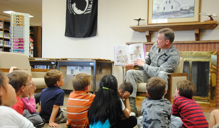 Col. Tim Gibson, 71st Mission Support Group commander, reads to kindergarteners from Eisenhower Elementary School at the Vance Library as part of National Library Week. (U.S. Air Force Photo/ Ensign Rex Miller)