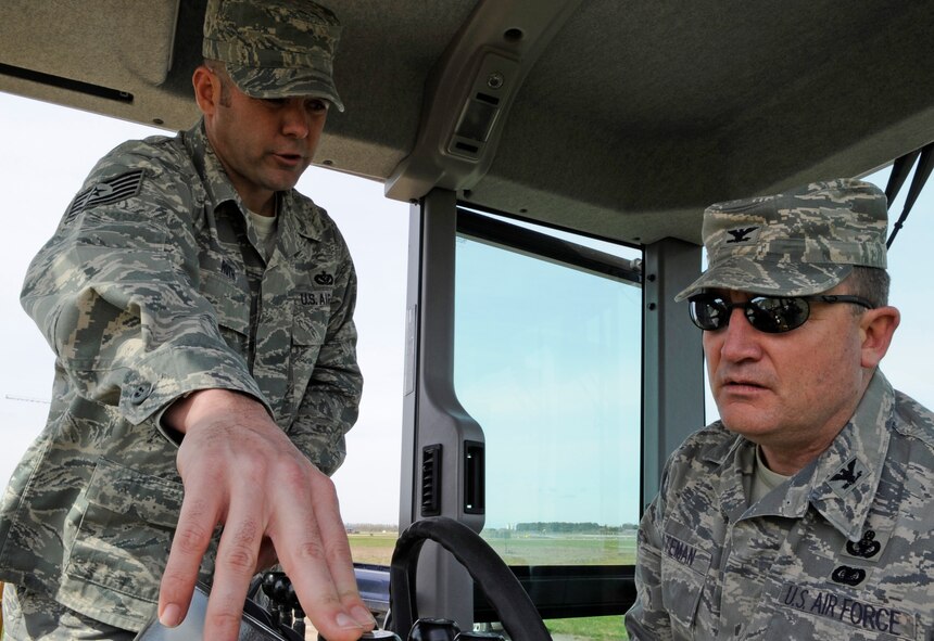 RAF MILDENHALL, England – Col. Jeffery Bateman, 100th Mission Support Group commander, learns the operational controls of a grader from Tech. Sgt. Adrian Roth, 100th Civil Engineer Squadron, April 13.  After brief instruction, Colonel Bateman proceeded to level a gravel road on the south side of the base.  (U.S. Air Force photo by/Staff Sgt. Christopher L. Ingersoll) 