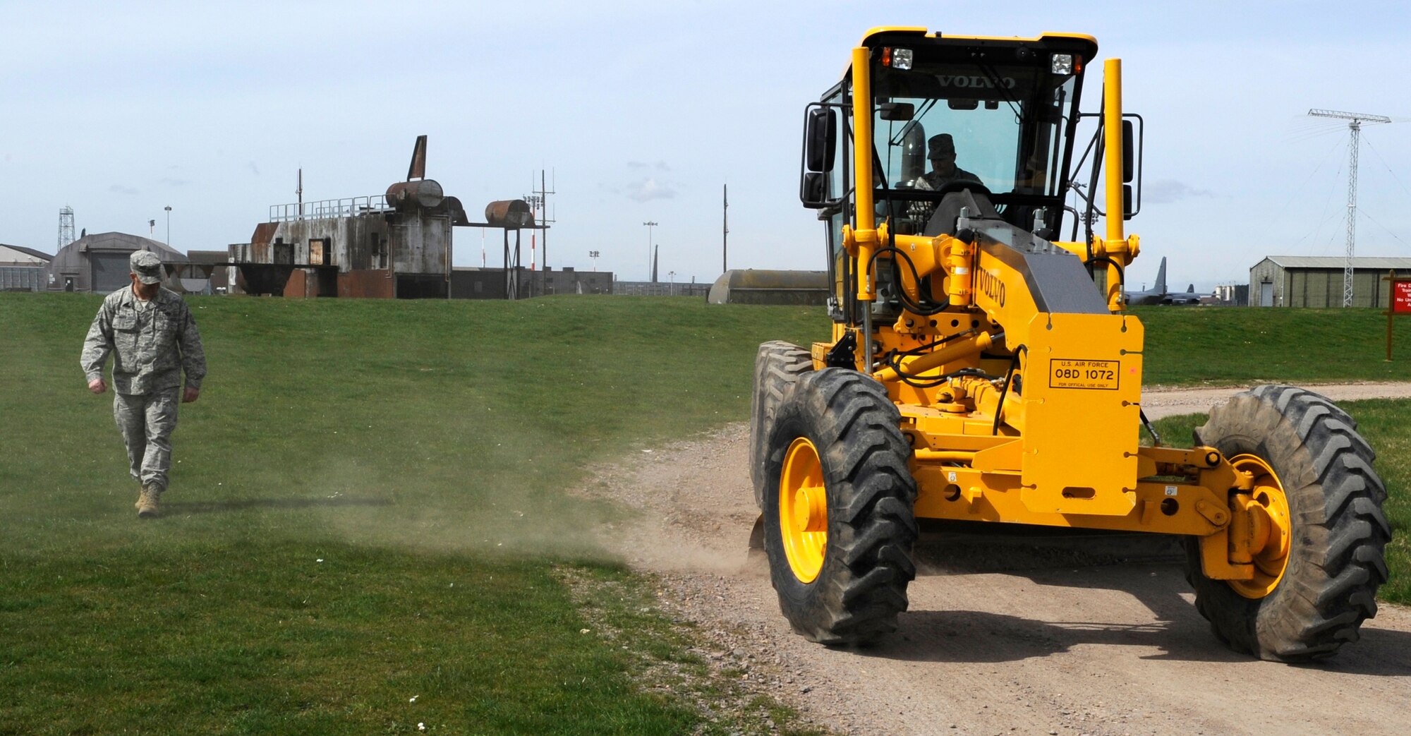 RAF MILDENHALL, England – Col. Jeffery Bateman, 100th Mission Support Group commander, learns how to drive a grader from Tech Sgt. Adrian Roth, 100th Civil Engineer Squadron, April 13.  Driving the grader is one in a series of experiences Colonel Bateman has had in an effort to experience what those in his command do on a daily basis.  (U.S. Air Force photo/Staff Sgt. Christopher L. Ingersoll)