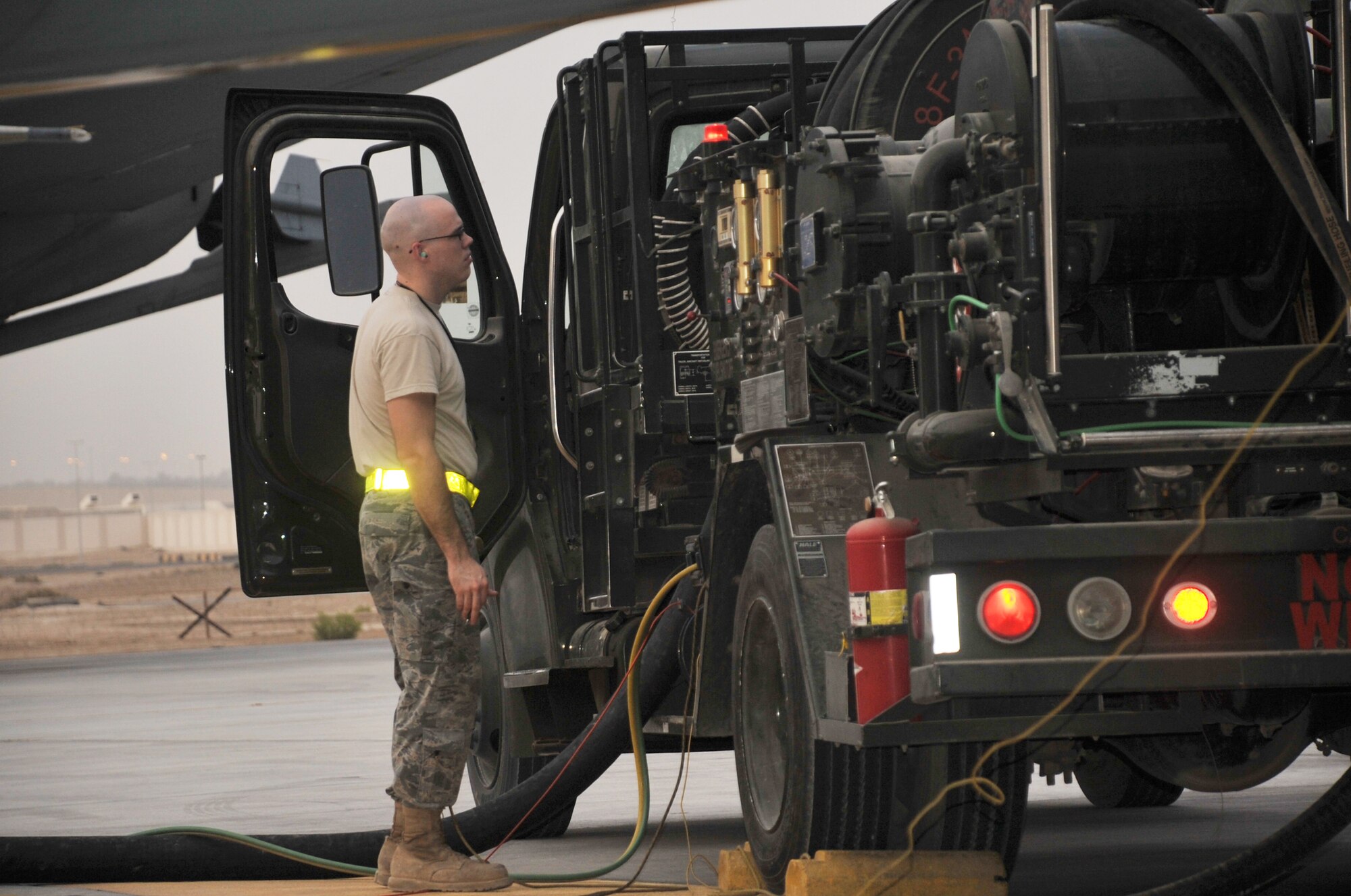 Senior Airman Israel Walker, fuels distribution journeyman deployed with the 380th Expeditionary Logistics Readiness Squadron fuels management flight, uses an R-12 fuels truck to refuel a plane on the flightline for the 380th Air Expeditionary Wing at a non-disclosed base in Southwest Asia on April 9, 2010. The 380th AEW and the 380th ELRS fuels management flight operate the Air Force's second largest deployed fuels operation in the U.S. Central Command area of responsibility. Airman Walker is deployed from Spangdahlem Air Base, Germany, and his hometown is Pella, Iowa. (U.S. Air Force Photo/Master Sgt. Scott T. Sturkol/Released)