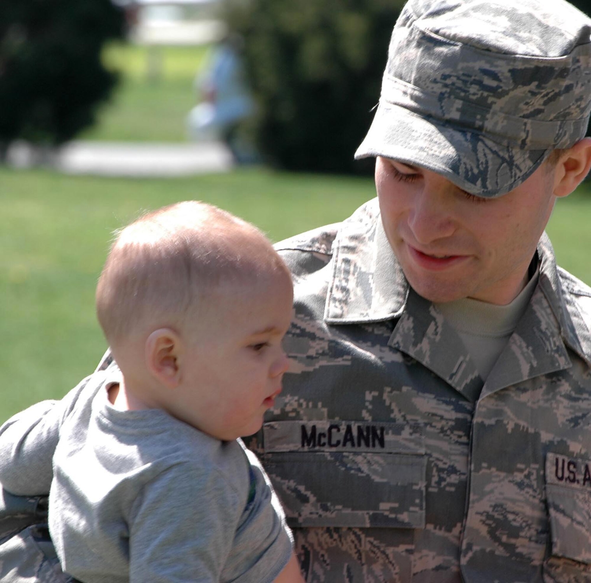 Staff Sgt. Kevin McCann II, 512th Maintenance Squadron sheet metal specialist, holds his son Kevin McCann III during the resource fair April 10 at the Eagles Nest picnic area. The fair had information tables set up for the families of the approximately 300 mobilized members, as well as food and amusements for children of the 512th Airlift Wing. (U.S Air Force photo/Staff Sgt. James Bolinger)
