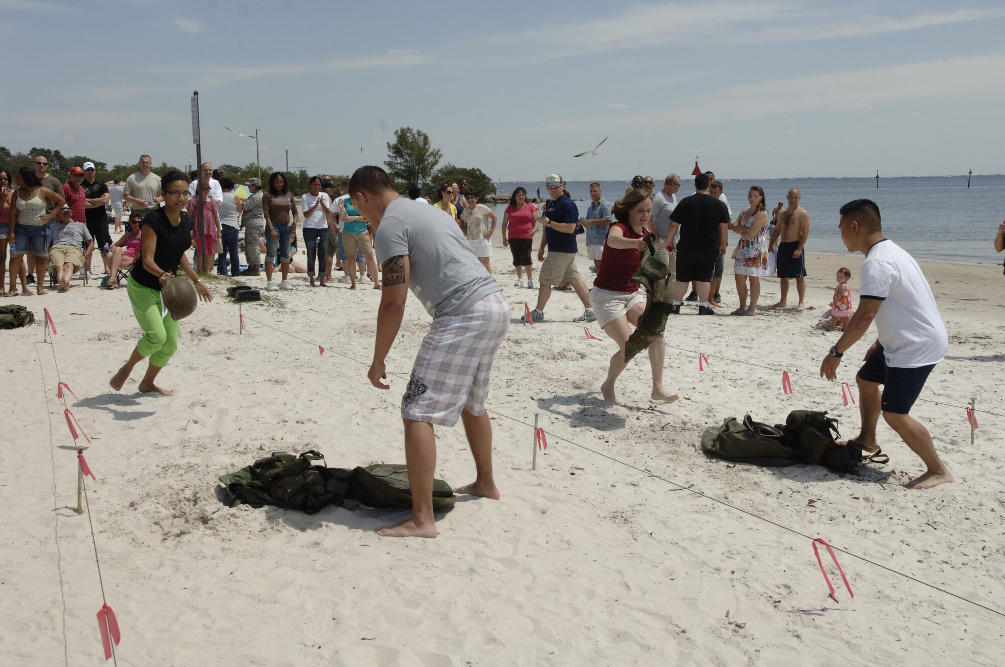 Teams race to be the first to complete the beach obstacle challenge (U.S. Air Force photo by Tech. Sgt. Denise Hauser)