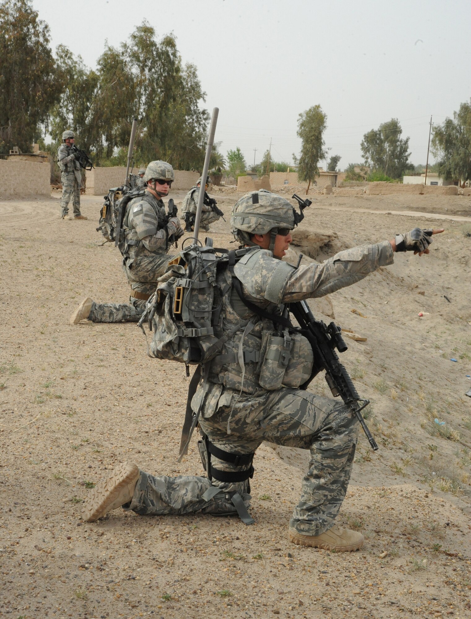 Members of the 732nd Expeditionary Security Forces Squadron, Detachment 2 scan the area for possible activity during the joint presence patrol near Rufush, Iraq, April 4, 2010. The 732nd Expeditionary Security Forces, Detachment 2, conducted a “training and mentoring” mission, which was requested by the local police. During this mission, Air Force personnel trained the police in community policing and assisted with patrolling through a village recently overwhelmed by terrorist attacks.  (U.S. Air Force photo/Master Sgt. Trish Bunting/Released)