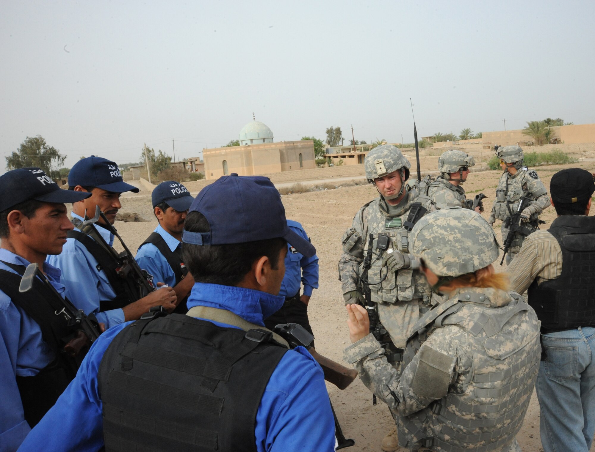 Members of the 732nd Expeditionary Security Forces Squadron, Det. 2 discuss the joint presence patrol near Rufush, Iraq, April 4, 2010. The 732nd Expeditionary Security Forces, Detachment 2, conducted a “training and mentoring” mission, which was requested by the local police. During this mission, Air Force personnel trained the police in community policing and assisted with patrolling through a village recently overwhelmed by terrorist attacks. (U.S. Air Force photo/Master Sgt. Trish Bunting/Released)
