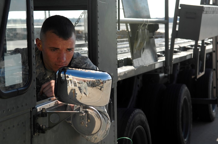 Airman 1st Class Michael Speaks backs up a  Tunner 60K loader after off-loading two mine-resistant, ambush-protected all-terrain vehicles at the 437th Aerial Port Squadron  March 23, 2010, at Joint Base Charleston, S.C. Airman Speaks is an air transportation technician with the 437th Aerial Port Squadron. (U.S. Air Force photo/Senior Airman Timothy Taylor)