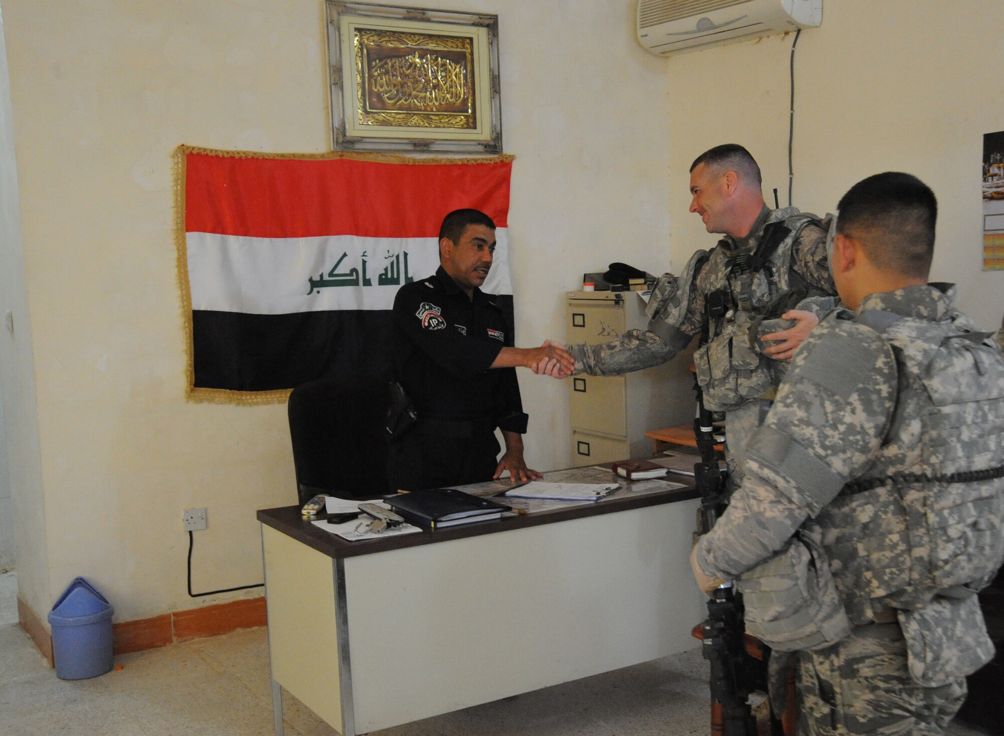 Air Force Master Sgt. William Boyden (center) and Staff Sgt. Christopher Flores, both from the 732nd Expeditionary Security Forces Squadron, Detachment 2, shake hands with the local Iraqi Police Station Commander before beginning a joint presence patrol near Rufush, Iraq, April 4, 2010. The 732nd Expeditionary Security Forces, Detachment 2, conducted a “training and mentoring” mission, which was requested by the local police. During this mission, Air Force personnel trained the police in community policing and assisted with patrolling through a village recently overwhelmed by terrorist attacks.  (U.S. Air Force photo/Master Sgt. Trish Bunting/Released)