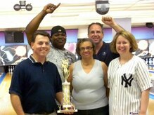 From left, Brian Jones, Tamir Brooks, Colette Martinez, David Shuff and Cynthia Shuff show off their championship trophy April 7, 2010, at the Starlifter Lanes on Joint Base Charleston, S.C., after the 628th Logistics Readiness Squadron's Team LRS 1 captured the 2009/2010 intramural season base bowling championship. The 28-week season concluded at the Starlifter Lanes with the top eight teams from the intramural bowling leagues, battling it out over three nights of roll-offs. Team LRS 1 led after each night and never relinquished their lead. The 437th Maintenance and 437th Aircraft Maintenance Squadrons tried their best to make a run at LRS, but their charge fell a bit short. They finished second and third respectively. Team LRS 1 members include Mr. Jones, Mr. Brooks, Jason Maine, Mr. and Mrs. Shuff, Howard Goins, Ms. Martinez and Butch Reinhart.