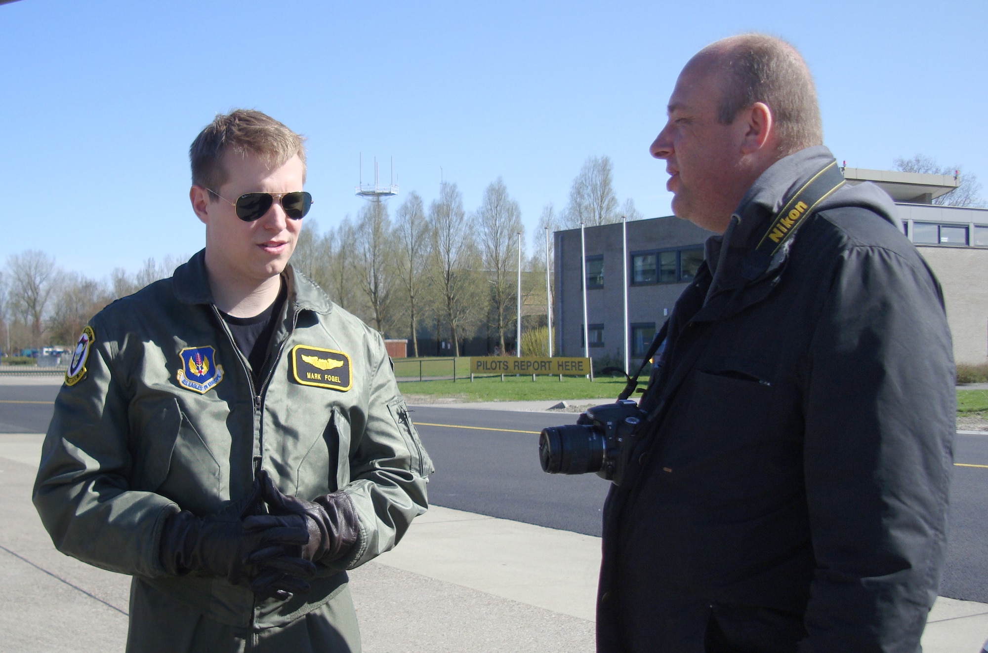Capt. Mark Fogel, 493rd Fighter Squadron, talks about the role of the F-15C in FRISIAN FLAG 2010 to a member of the Dutch press April 13 at Leeuwarden Air Base, The Netherlands.  Dutch media was invited to the base and given an opportunity to meet and interview the multi-national personnel participating in the exercise, understand the purpose of the event and see the aircraft from each country. (U.S. Air Force photo/1st Lt. Haley Ageton) 
