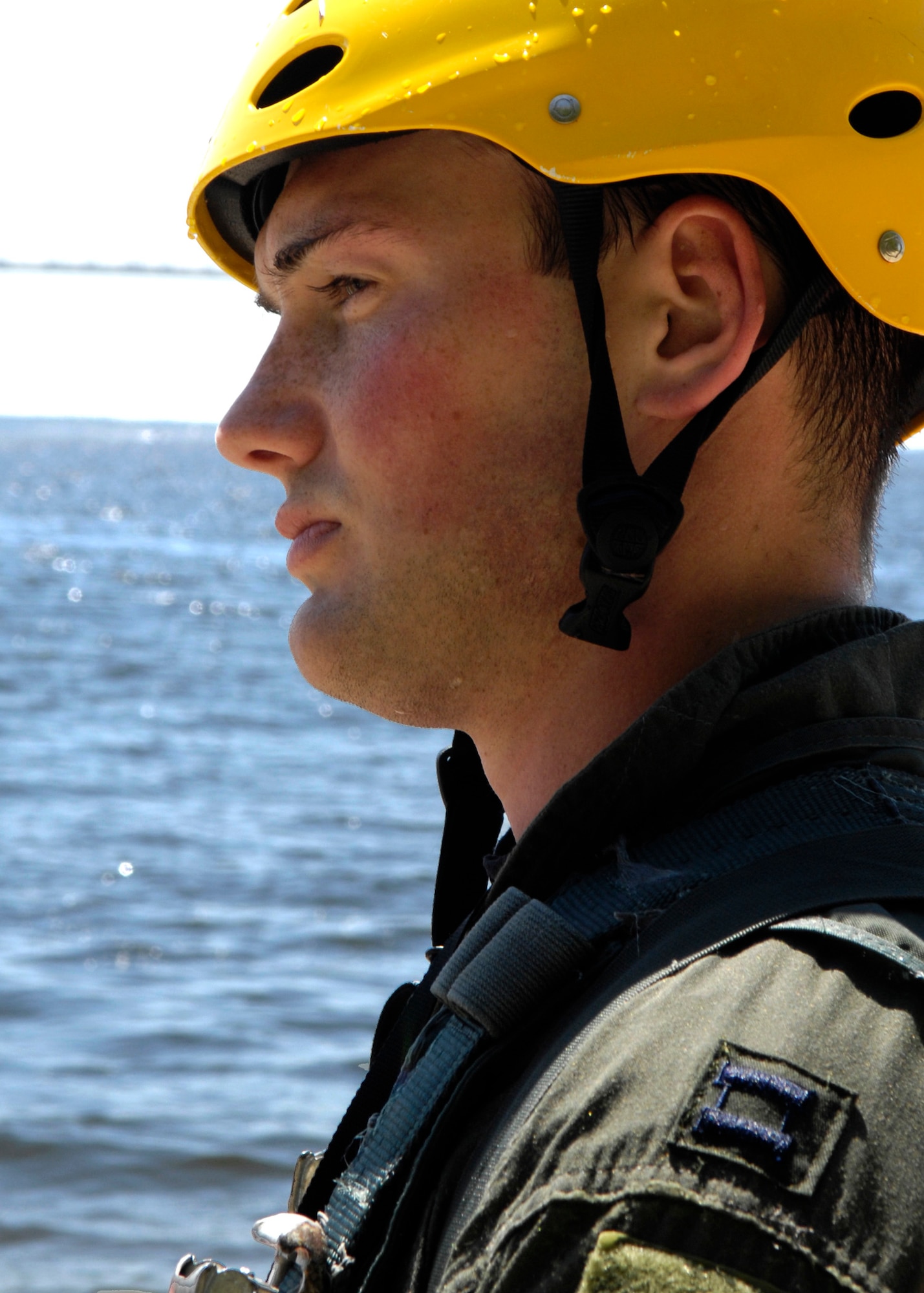 U.S. Air Force Capt. John Schilling rests after a taxing Survival, Evasion, Resistance and Escape training class on the Charleston Harbor in Charleston, S.C., April 5, 2010. The refresher course is mandatory for all pilots and aircrew members to maintain currency with their training in the event of an aircraft emergency. The aircrew had to complete a number of tasks, including jumping into the water in full uniform and crawl out onto a one-man raft. Captain Schilling is a C-17 pilot with the 15th Airlift Squadron. (U.S. Air Force Photo/Airman 1st Class Lauren Main)