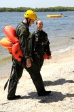 U.S. Air Force Capt. John Schilling and Staff Sgt. Lindy Snodgrass emerge onto the shore after water survival training in the Charleston Harbor in Charleston, S.C., April 5, 2010. All aircrew members are required to complete Survival, Evasion, Resistance, Escape training once every three years. The water survival course is designed to teach the aircrew how to survive in the event an aircraft emergency should land them in the water. During the training aircrew members complete numerous grueling tasks, one of which requires them to be drug behind a boat in a parachute harness while they attempting to release themselves and swim to shore. Captain Schilling is a C-17 pilot and Sergeant Snodgrass is a loadmaster; both are with the 15th Airlift Squadron. (U.S. Air Force Photo/Airman 1st Class Lauren Main)