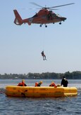 A U.S. Coast Guard rescue diver is lowered into the Charleston Harbor in Charleston, S.C., from a helicopter during a Survival, Evasion, Resistance and Escape refresher course for aircrew from Joint Base Charleston, S.C., April 5, 2010. The Coast Guard and Air Force team-up for joint training twice a month to teach the aircrew members how to survive in the event of an aircraft emergency. The Coast Guard uses the water survival class as an opportunity to train their rescue divers how to lift victims out of the water and administer proper care. (U.S. Air Force Photo/Airman 1st Class Lauren Main)