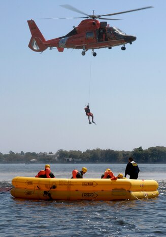 A U.S. Coast Guard rescue diver is lowered into the Charleston Harbor in Charleston, S.C., from a helicopter during a Survival, Evasion, Resistance and Escape refresher course for aircrew from Joint Base Charleston, S.C., April 5, 2010. The Coast Guard and Air Force team-up for joint training twice a month to teach the aircrew members how to survive in the event of an aircraft emergency. The Coast Guard uses the water survival class as an opportunity to train their rescue divers how to lift victims out of the water and administer proper care. (U.S. Air Force Photo/Airman 1st Class Lauren Main)