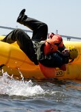 U.S. Air Force Staff Sgt. Francis Nelson dives into the Charleston Harbor in Charleston, S.C., during a water survival class April 5, 2010. The class is part of the Survival, Evasion, Resistance and Escape training each pilot and aircrew member are required to complete every three years. SERE is part of the Air Force's "Guardian Angel" weapons system which also includes pararescumen and combat rescue officers. SERE speacilists are considered special operations and currently are the only special operations career in the Air Force which allows females. Sergeant Nelson is a loadmaster with the 16th Airlift Squadron. (U.S. Air Force Photo/Airman 1st Class Lauren Main)