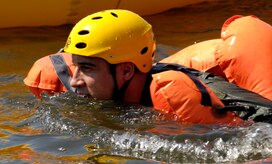 U.S. Air Force Capt. Matthew Slupski swims toward a one-man raft after jumping into the Charleston Harbor in Charleston, S.C., during a refresher Survival, Evasion, Resistance and Escape training course April 5, 2010. The water survival class is mandatory for all aircrew members and has to be accomplished every three years. Captain Slupski made his initial leap into the water from a 46-man raft. Each aircraft is equipped with three of the large rafts and can be deployed out of the top of the aircraft. Captain Slupski is a C-17 pilot with the 15th Airlift Squadron. (U.S. Air Force Photo/Airman 1st Class Lauren Main)