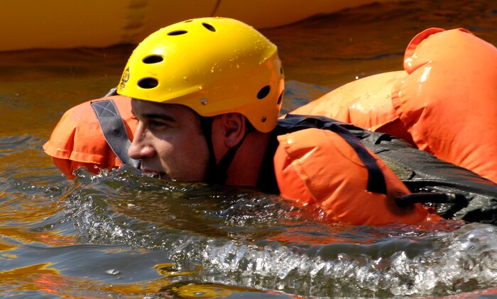 U.S. Air Force Capt. Matthew Slupski swims toward a one-man raft after jumping into the Charleston Harbor in Charleston, S.C., during a refresher Survival, Evasion, Resistance and Escape training course April 5, 2010. The water survival class is mandatory for all aircrew members and has to be accomplished every three years. Captain Slupski made his initial leap into the water from a 46-man raft. Each aircraft is equipped with three of the large rafts and can be deployed out of the top of the aircraft. Captain Slupski is a C-17 pilot with the 15th Airlift Squadron. (U.S. Air Force Photo/Airman 1st Class Lauren Main)